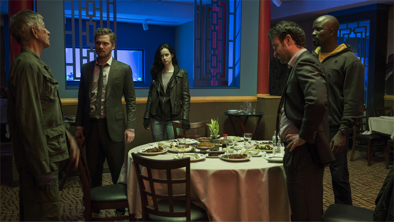 Stick (Scott Glenn), Danny Rand (Finn Jones), Jessica Jones (Krysten Ritter), Matt Murdock (Charlie Cox), and Luke Cage (Mike Colter) enjoy some Chinese food and prepare to be attacked by weird Ninjas in The Defenders.
